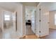 Bright hallway featuring access to the bathroom and a bedroom, both with open doors at 3048 Cherokee Rd, St Cloud, FL 34772