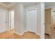 Hallway featuring a closet with bi-fold doors and light wood flooring leading to rooms at 3048 Cherokee Rd, St Cloud, FL 34772