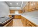 Well-lit kitchen featuring wooden cabinets, stainless steel appliances, and a long countertop at 3048 Cherokee Rd, St Cloud, FL 34772
