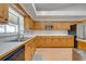 Bright kitchen with wooden cabinetry, white countertops, stainless appliances and lots of counter space at 3048 Cherokee Rd, St Cloud, FL 34772