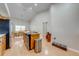 Open kitchen area featuring a central island with cooktop and stainless steel appliances and light wood flooring at 3048 Cherokee Rd, St Cloud, FL 34772