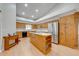 Spacious kitchen featuring wooden cabinets, an island, stainless steel appliances, and hardwood floors at 3048 Cherokee Rd, St Cloud, FL 34772