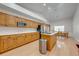 Open-concept kitchen with stainless steel appliances, center island, and wooden cabinets at 3048 Cherokee Rd, St Cloud, FL 34772