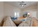 Bright living room featuring vaulted ceilings, a ceiling fan, wood floors, and patio access at 3048 Cherokee Rd, St Cloud, FL 34772