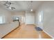 Open-concept living room with vaulted ceilings, wood-look flooring, and abundant natural light at 3048 Cherokee Rd, St Cloud, FL 34772