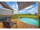 Charming pool featuring a wooden deck and shade, providing a cool respite on a hot day at 3048 Cherokee Rd, St Cloud, FL 34772