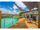 Above ground pool with wooden deck and shade canopies, perfect for backyard relaxation and entertainment at 3048 Cherokee Rd, St Cloud, FL 34772