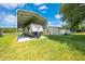 Spacious RV cover and additional shed storage on a well-maintained, grassy property at 3048 Cherokee Rd, St Cloud, FL 34772