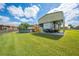 Metal RV cover with RV, pool, and well maintained lawn on property at 3048 Cherokee Rd, St Cloud, FL 34772