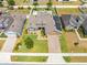 Aerial front view of home highlighting landscaping, solar panels, brick driveway, and two car garage at 3101 Drema Dr, St Cloud, FL 34769