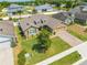 Aerial view of the single-story home featuring a well-manicured lawn and brick driveway at 3101 Drema Dr, St Cloud, FL 34769