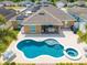 Aerial view of the backyard featuring a pool, spa, patio and solar panels at 3101 Drema Dr, St Cloud, FL 34769