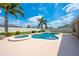 Lush backyard with a refreshing pool, hot tub, and manicured landscaping, perfect for relaxation at 3101 Drema Dr, St Cloud, FL 34769