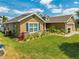 Attractive home exterior with lush landscaping, stone accents, and a well-kept lawn at 3101 Drema Dr, St Cloud, FL 34769
