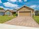 Charming home with a well-manicured lawn, beautiful landscaping, and a brick driveway at 3101 Drema Dr, St Cloud, FL 34769