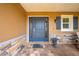 Inviting covered front porch with stone accents and a blue front door at 3101 Drema Dr, St Cloud, FL 34769