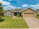 Charming single-story home featuring a well-manicured lawn, beautiful landscaping, and an inviting front entrance at 3101 Drema Dr, St Cloud, FL 34769