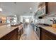Open kitchen with stainless steel appliances, granite countertops, breakfast bar, and tile backsplash at 3101 Drema Dr, St Cloud, FL 34769