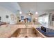 Kitchen island with stainless steel sink, granite countertops, and open view to the living area at 3101 Drema Dr, St Cloud, FL 34769