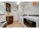 Laundry room with modern appliances, storage cabinets, and ample counter space at 3101 Drema Dr, St Cloud, FL 34769