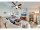 Spacious living room featuring a ceiling fan, hardwood floors, and a large comfortable sectional at 3101 Drema Dr, St Cloud, FL 34769