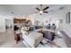 Bright, open-concept living area with hardwood floors, ceiling fan and views of kitchen and dining area at 3101 Drema Dr, St Cloud, FL 34769