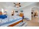 Inviting main bedroom with tray ceilings, a ceiling fan, and a view of the bathroom at 3101 Drema Dr, St Cloud, FL 34769