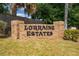 Neighborhood entrance sign, 'Lorraine Estates', surrounded by lush landscaping at 3101 Drema Dr, St Cloud, FL 34769
