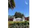 Landscaping and sign for The Enclaves Amenity Center under a bright blue sky at 313 Captiva Dr, Davenport, FL 33896