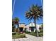 Arcade retail space and landscaped walkway with palm trees on a bright sunny day at 313 Captiva Dr, Davenport, FL 33896