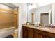 Bathroom featuring double sinks, granite counters, and a shower-tub combination at 313 Captiva Dr, Davenport, FL 33896