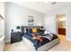 Comfortable bedroom with stylish decor, gray walls and furnishings, and ensuite bathroom entrance at 313 Captiva Dr, Davenport, FL 33896