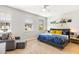 Bright bedroom featuring two sunny windows, comfortable bed, and relaxing sitting area at 313 Captiva Dr, Davenport, FL 33896