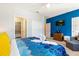 Bright bedroom featuring a vivid blue accent wall, a comfortable couch and a tv at 313 Captiva Dr, Davenport, FL 33896