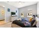 Comfortable bedroom with stylish decor, light gray walls, two windows and television at 313 Captiva Dr, Davenport, FL 33896