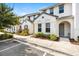 Attractive townhouse exterior featuring clean white stucco, gray trim and gray front doors at 313 Captiva Dr, Davenport, FL 33896