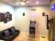 A well decorated game room with a black futon, vintage arcade game, and Pac-Personal themed art at 313 Captiva Dr, Davenport, FL 33896