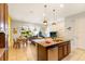 Modern kitchen with an island sink, granite countertops, and an open view of living space at 313 Captiva Dr, Davenport, FL 33896