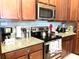 Well-equipped kitchen with stainless steel appliances and granite countertops at 313 Captiva Dr, Davenport, FL 33896