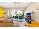 Cozy living room with comfortable seating, a ceiling fan, and a view of the screened lanai at 313 Captiva Dr, Davenport, FL 33896