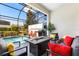 Relaxing screened patio with modern seating area and grill next to refreshing pool at 313 Captiva Dr, Davenport, FL 33896