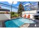 Sparkling swimming pool in screened lanai offers the perfect spot to relax and cool off at 313 Captiva Dr, Davenport, FL 33896