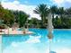 A pristine community pool with inviting cool blue water on a sunny day at 313 Captiva Dr, Davenport, FL 33896