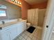 Bathroom featuring large white vanity, tile floors and shower over tub at 344 Winter Ridge Blvd # 344, Winter Haven, FL 33881