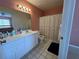 Bright bathroom featuring tile flooring, vanity with storage and shower at 344 Winter Ridge Blvd # 344, Winter Haven, FL 33881