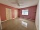 Spacious bedroom offers neutral tile flooring, closet and natural light at 344 Winter Ridge Blvd # 344, Winter Haven, FL 33881