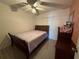 Well-lit bedroom with neutral colors, a comfortable bed, and a dresser with decorative accents at 344 Winter Ridge Blvd # 344, Winter Haven, FL 33881