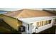 Rear exterior view of home showcasing the roof, patio, and yard at 344 Winter Ridge Blvd # 344, Winter Haven, FL 33881