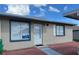 Charming single-story home featuring stucco siding, blue trim, and a well-manicured brick pathway at 344 Winter Ridge Blvd # 344, Winter Haven, FL 33881