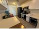 Functional kitchen featuring white cabinets, modern appliances and a convenient desk area at 344 Winter Ridge Blvd # 344, Winter Haven, FL 33881